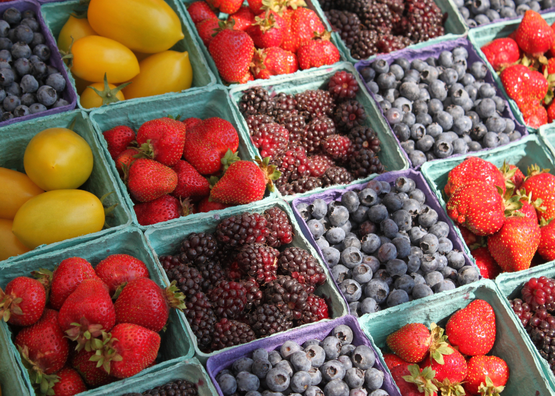 Fresh berries packaged in cardboard at the farmer's market.