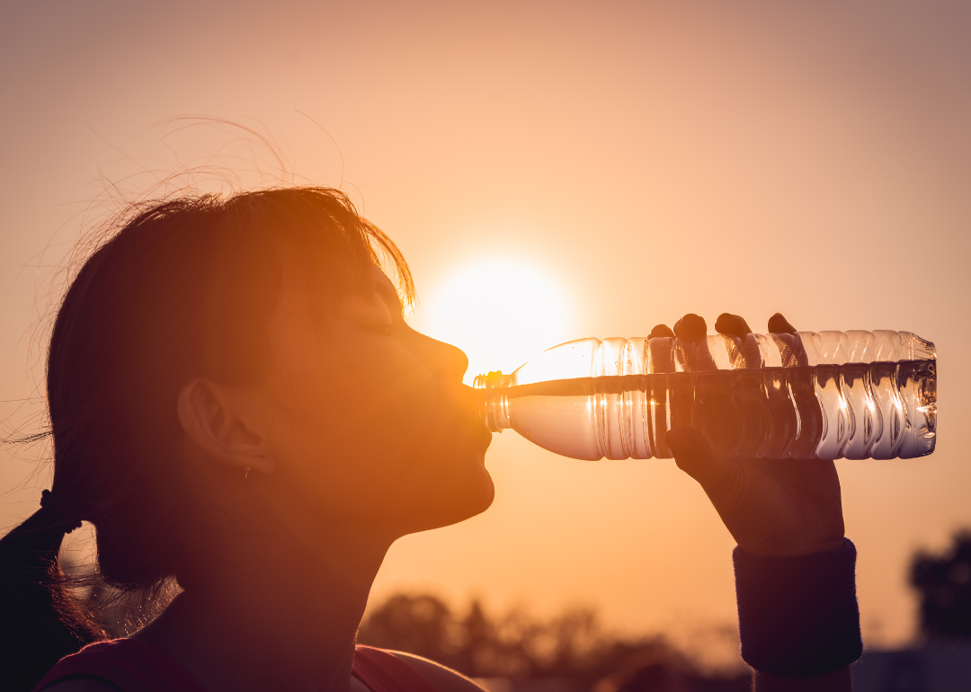 A person drinking water during a heat wave