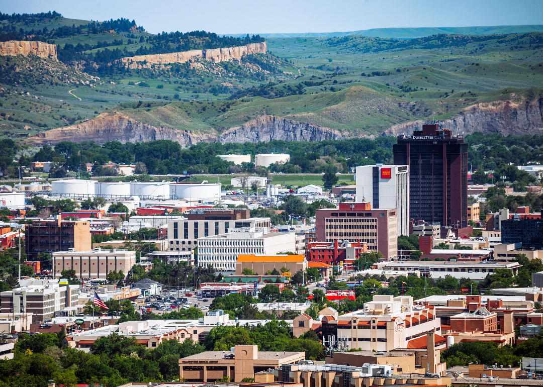 Buildings in Billings, Montana, with scenic hills in the background.