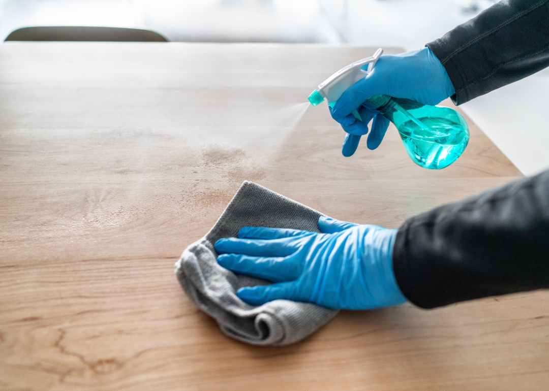 A person using a natural solution to clean wood.