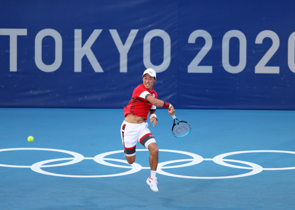 Kei Nishikori of Team Japan hitting a forehand during his Men's Singles First Round match against Andrey Rublev of Team ROC on day two of the Tokyo 2020 Olympic Games at Ariake Tennis Park