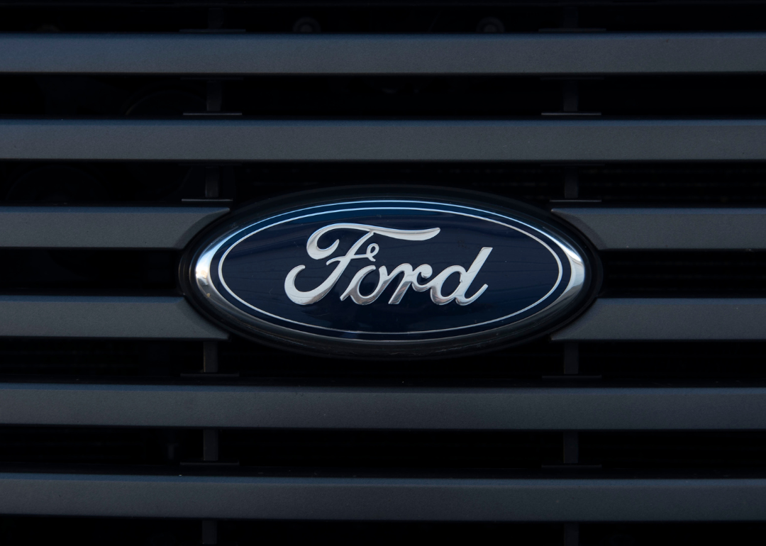 A black and silver Ford logo on the front of a truck.