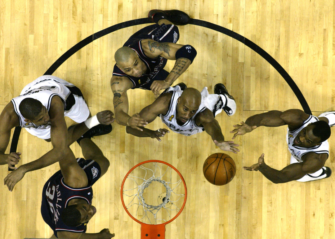 Bruce Bowen #12 and David Robinson #50 of the San Antonio Spurs team up for a rebound against the New Jersey Nets in game six of the 2003 NBA Finals.