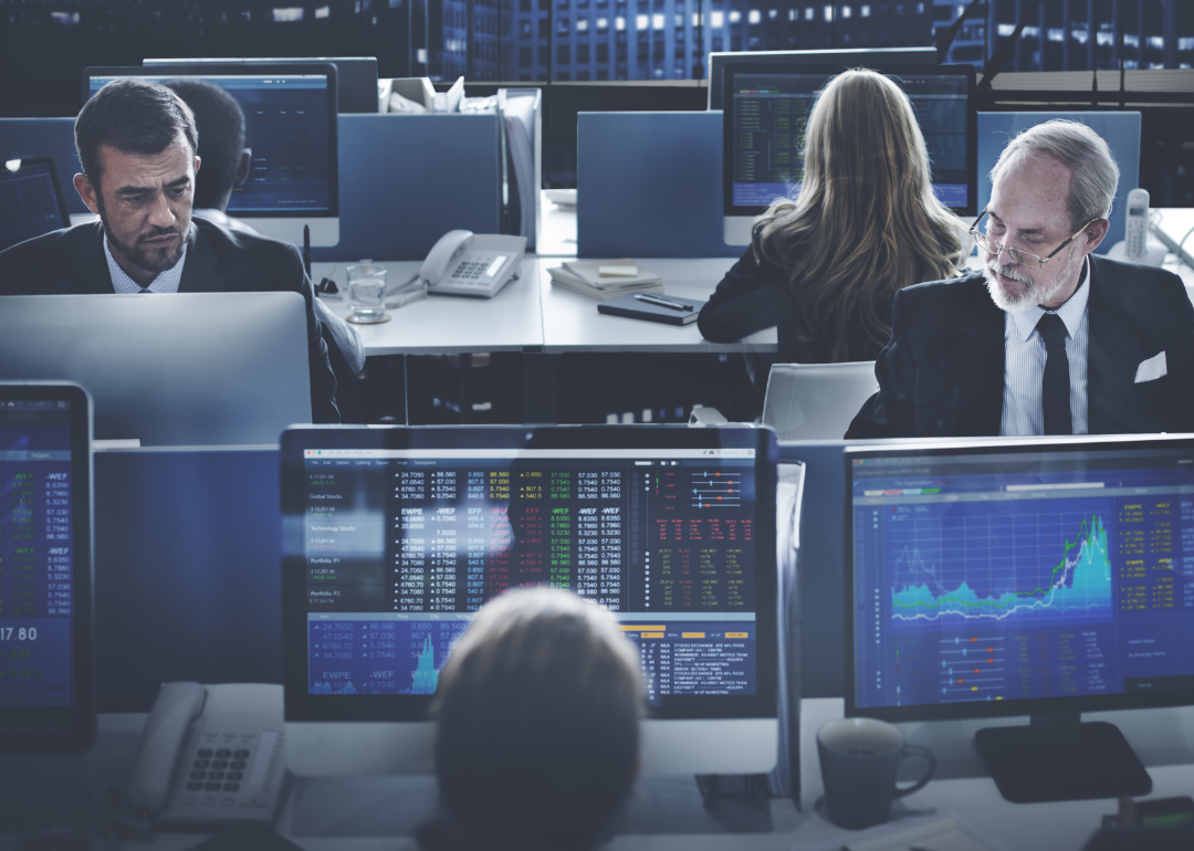 Financial technologists working on their desktops in an office.