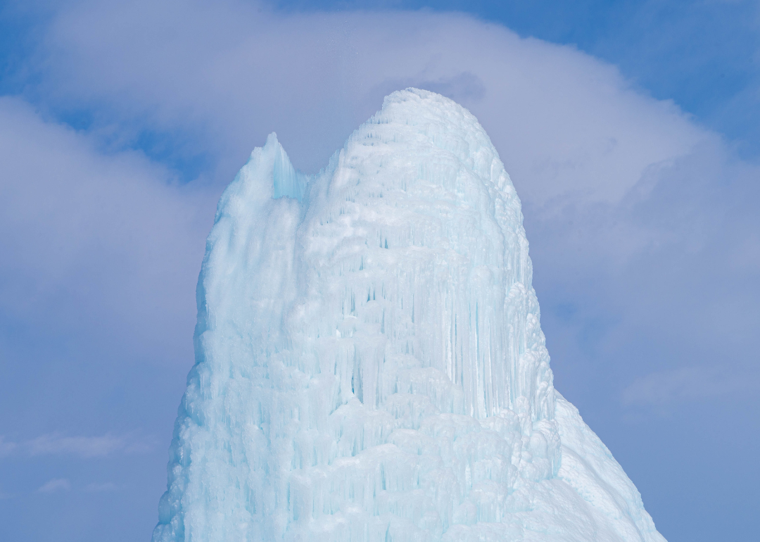 An ice volcano in front of a blue sky.