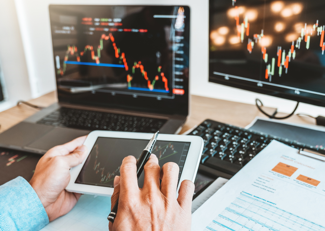 A business person looking at a graph that pictures current stock market conditions