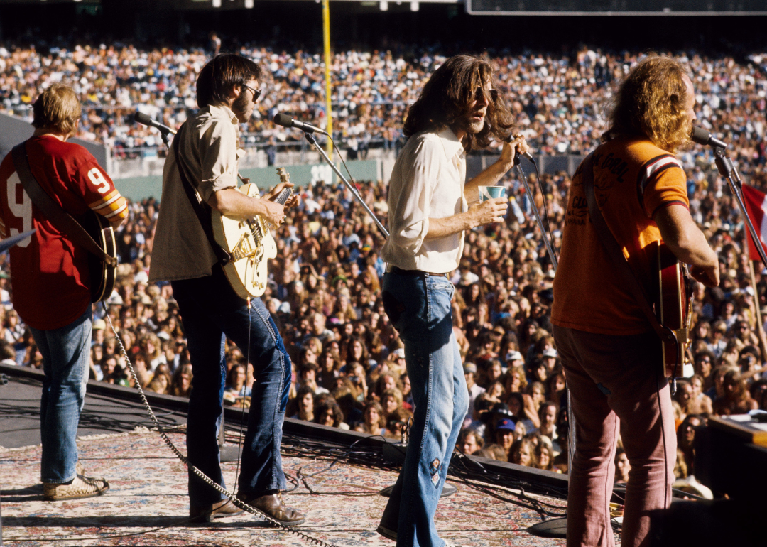 Stephen Stills, Neil Young, Graham Nash, and David Crosby of Crosby, Stills, Nash, And Young performing on stage at Oakland Colisseum on July 13, 1974, in Oakland, California.