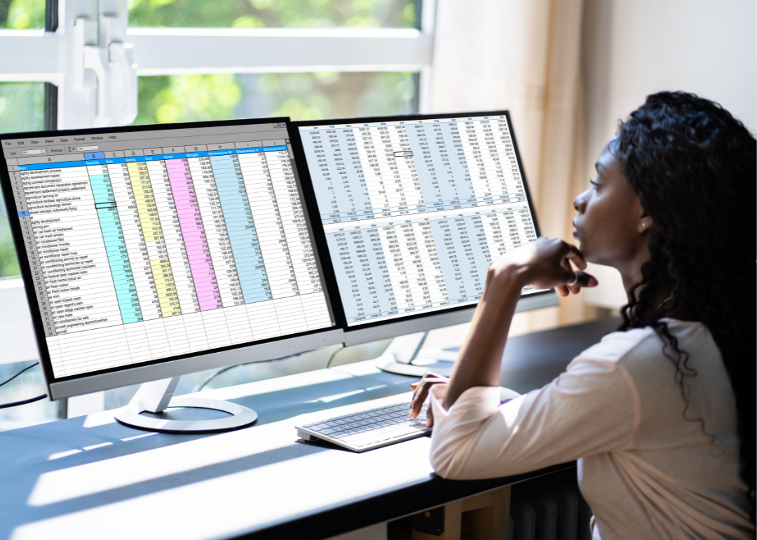 A data analyst looking at spreadsheets on their computer.