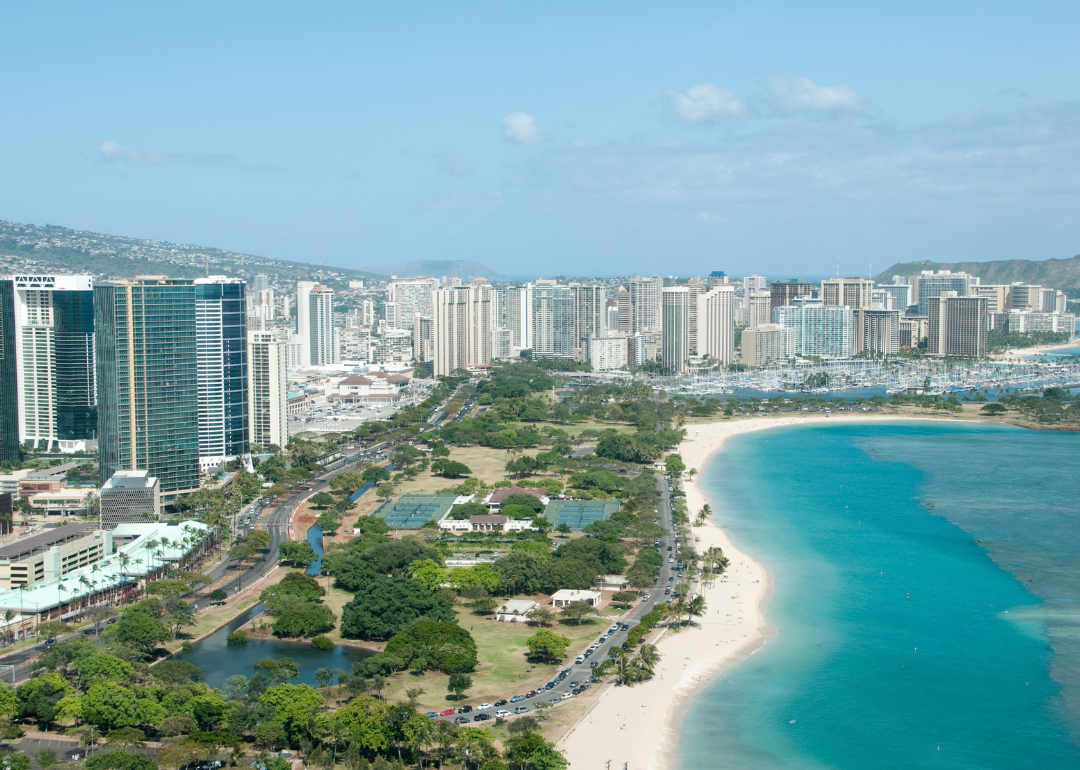 An aerial view of a beach and buildings in Honolulu.