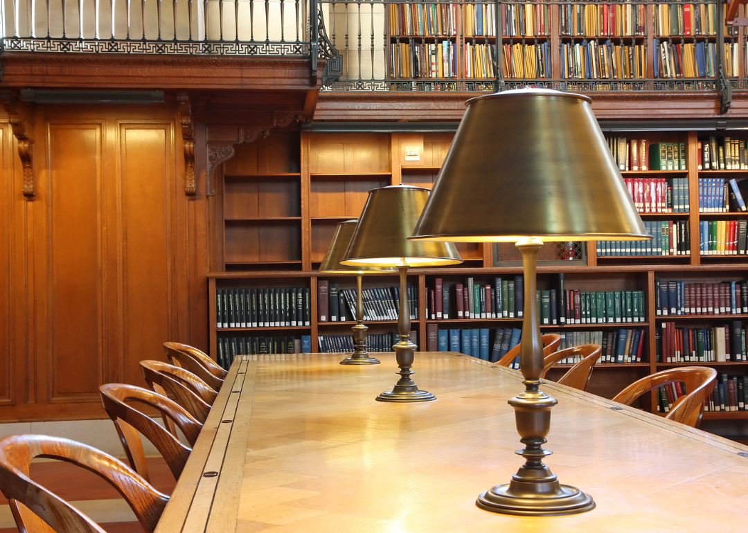 A library desk with large lamps.