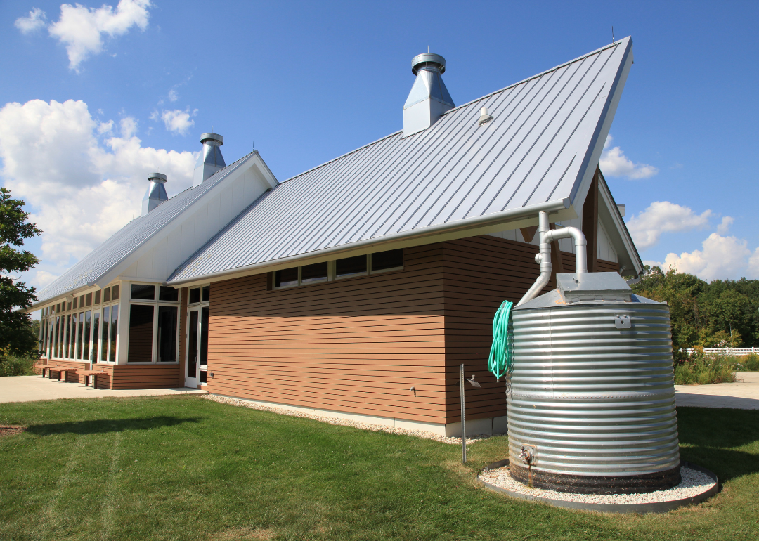 A modern, silver cistern collecting rainwater in Riverwoods.