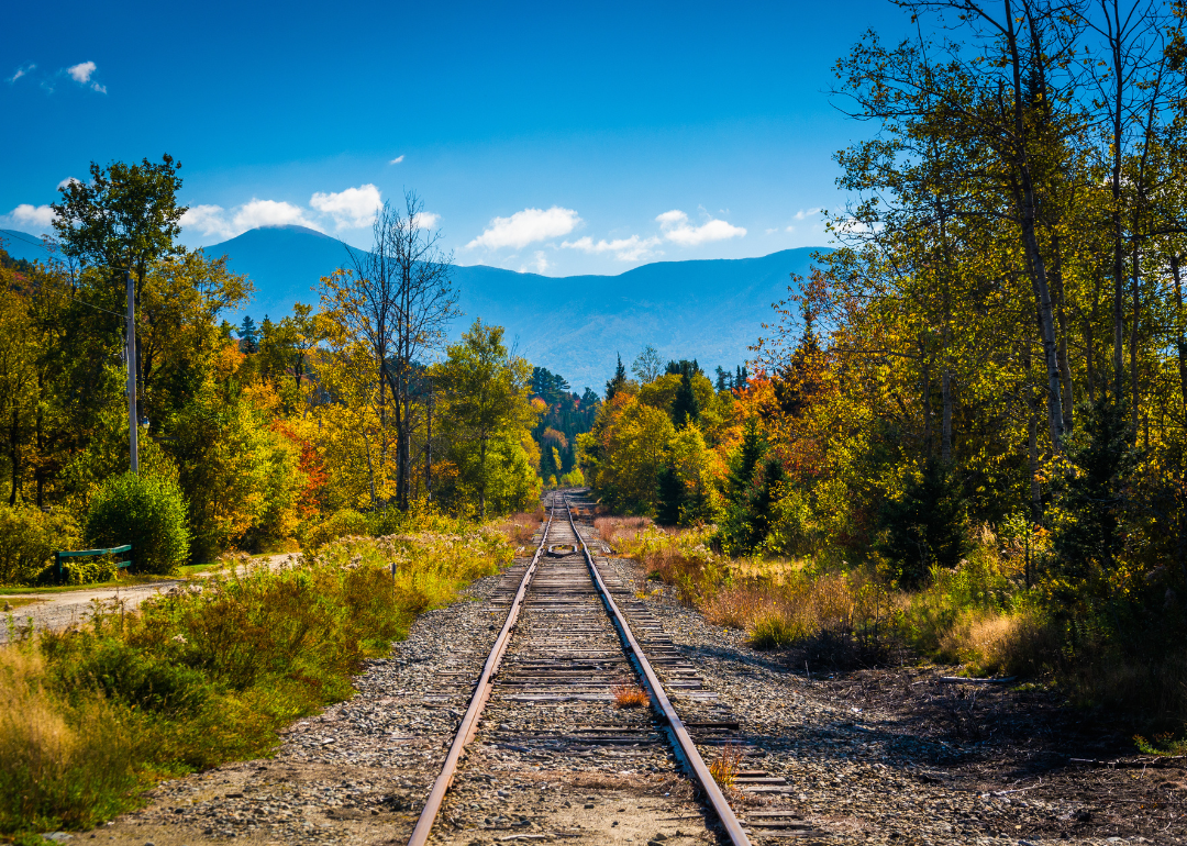 Railroad tracks and distant mountains as seen in White Mountain National Forest.