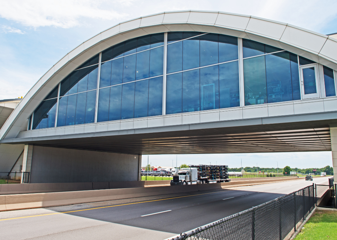 A truck passing under the Will Rogers Archway, a highway rest area spanning Interstate 44.