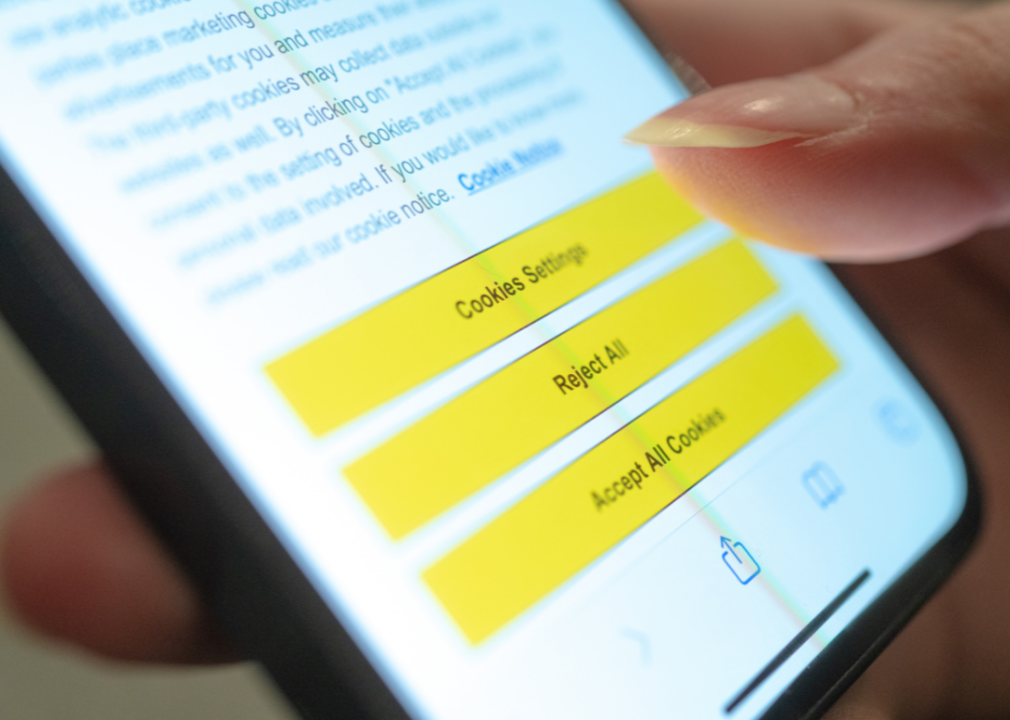 A person prompted on their mobile phone to accept cookies in a browser on a website