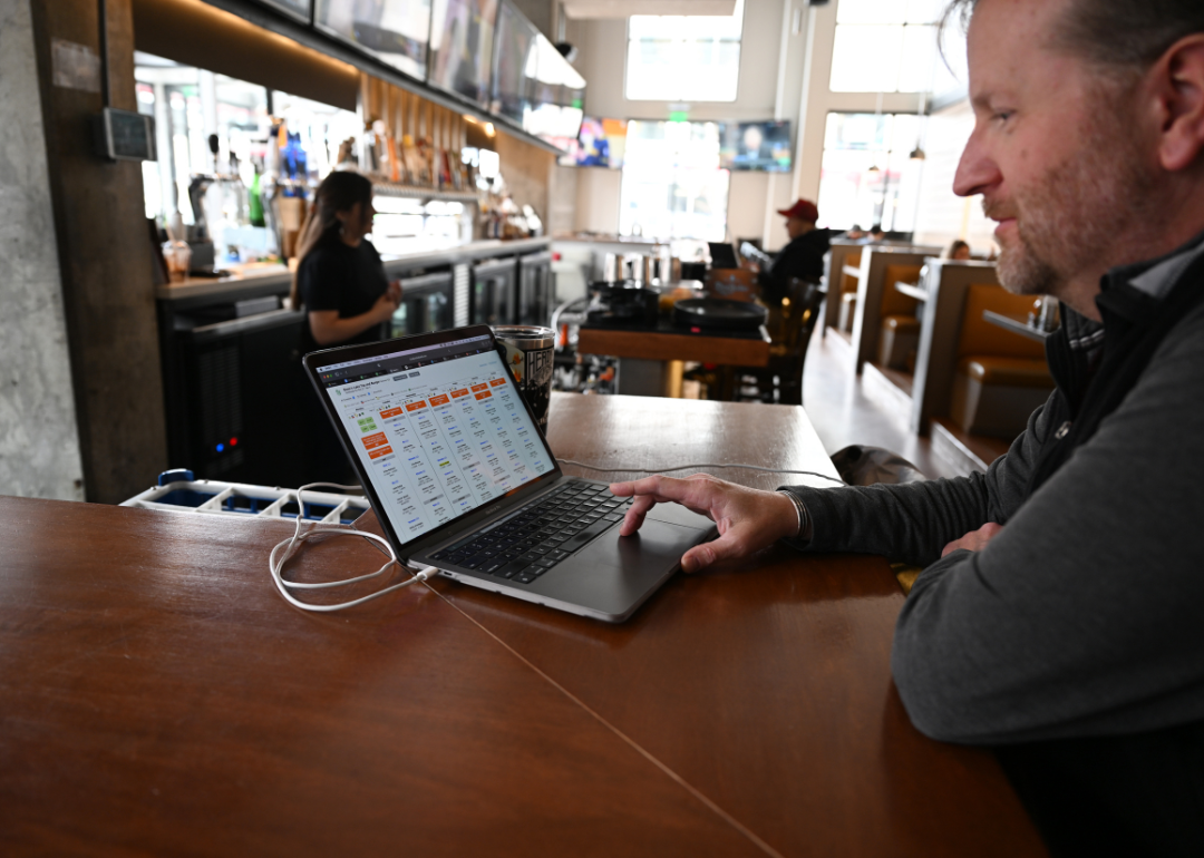 Mike McGill, a manager at Tap & Burger Sloan's Lake, working on the staff schedule.