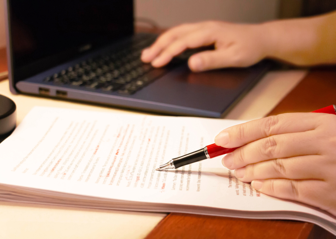 A pen traces the lines of a manuscript.