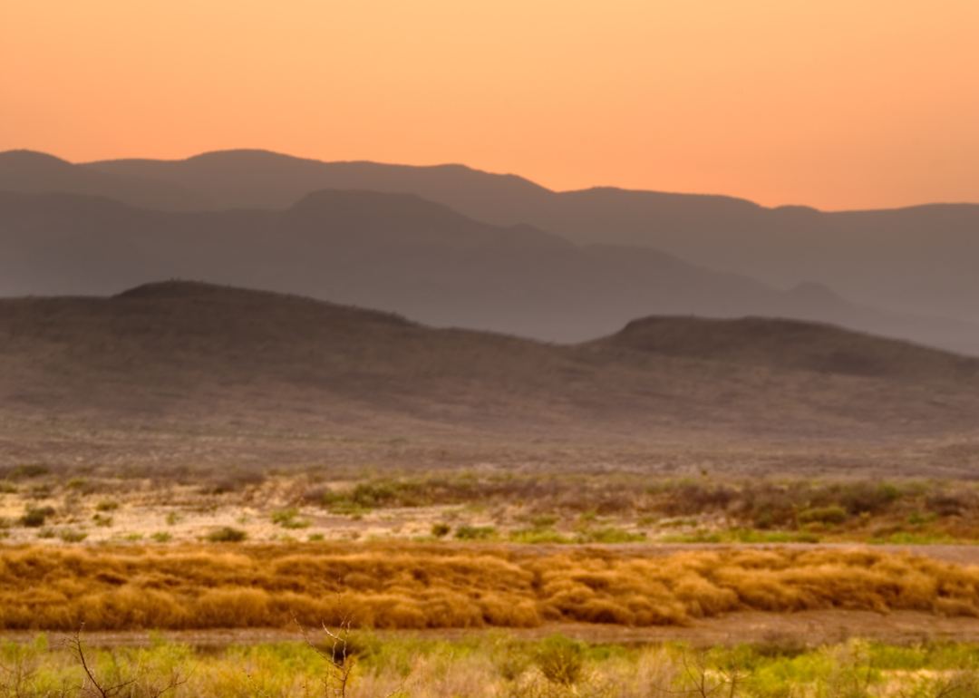 A desert in Texas with mountains in the background.