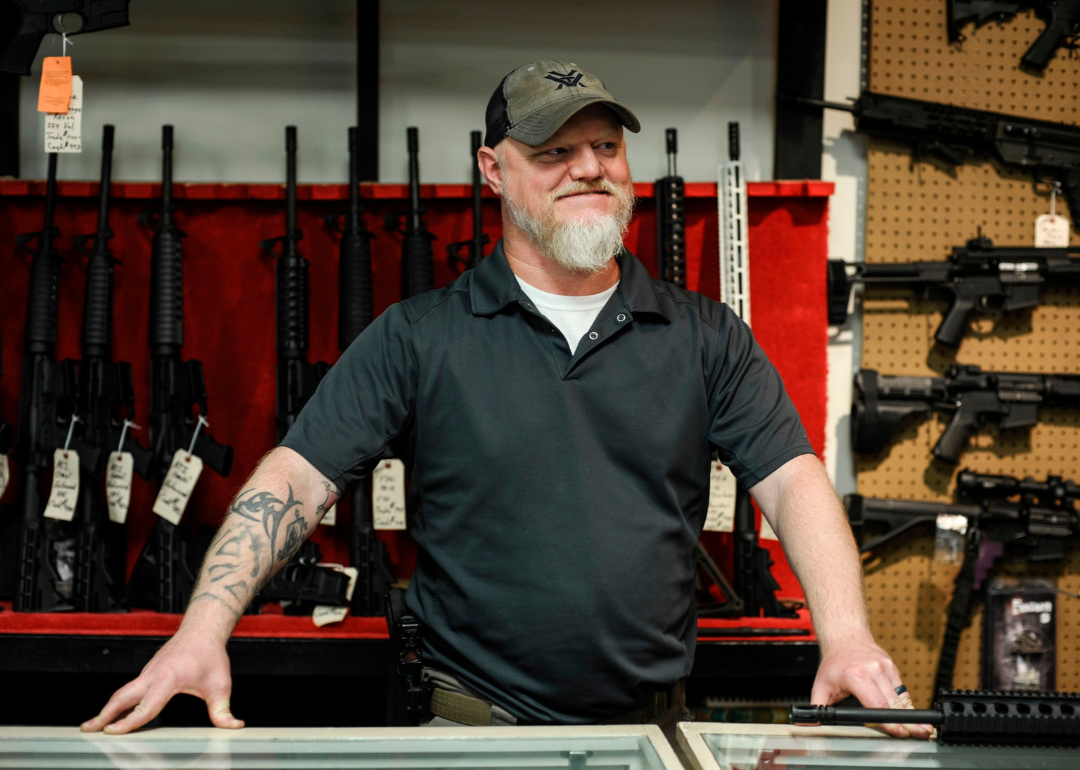 Chad Mercer speaking to Agence France-Presse from his booth at a gun shop in White Sulphur Springs.