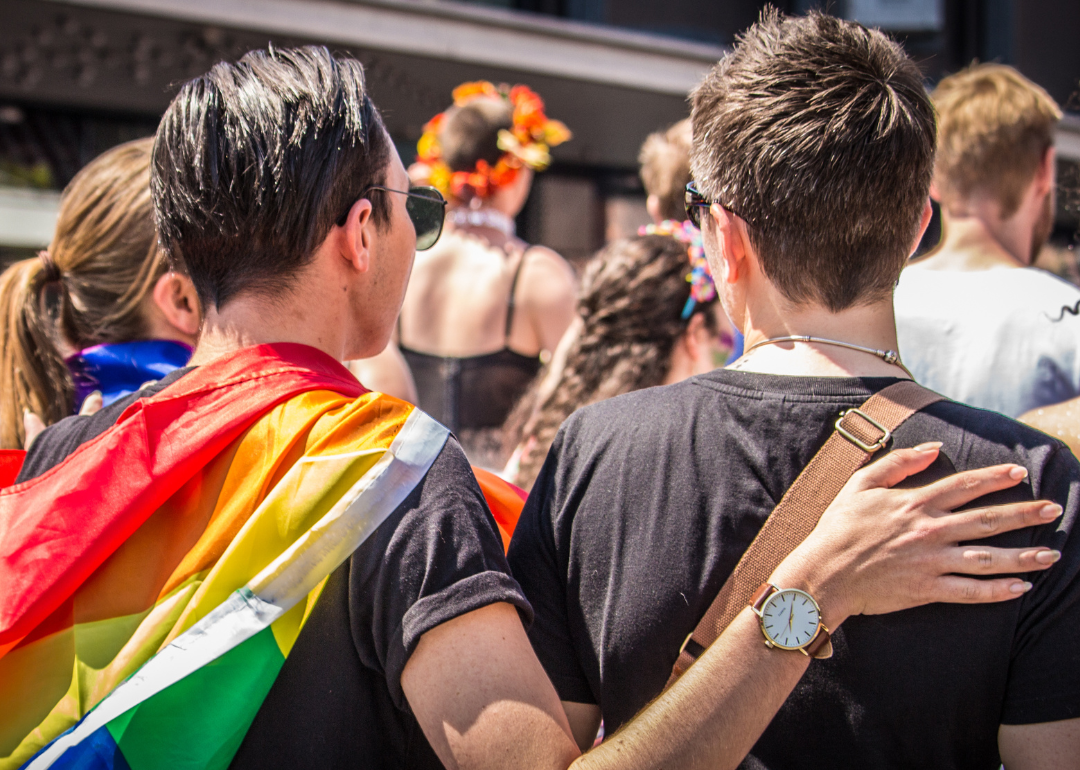 A gay couple at a pride parade.