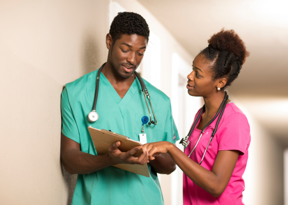 A nurse and a doctor discuss a patient's chart
