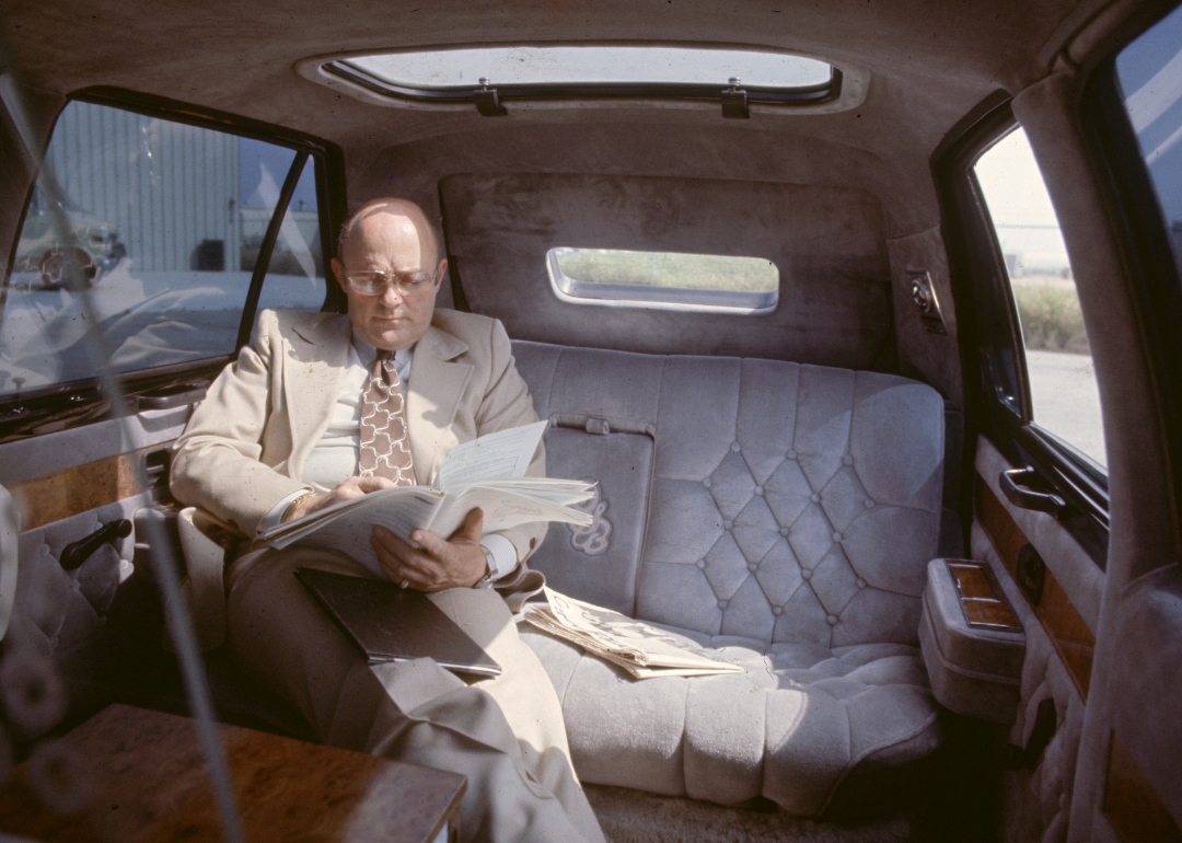 A man sitting inside a VW Rabbit.