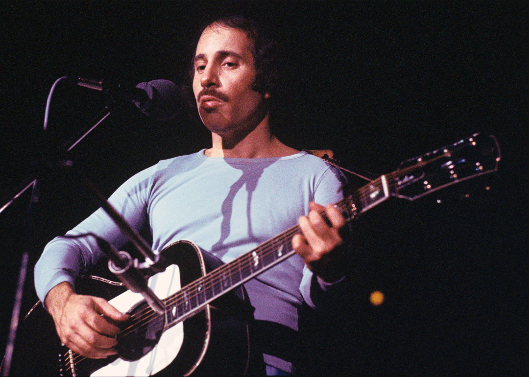 Paul Simon performing on stage in May 1973 in Amsterdam, Netherlands.