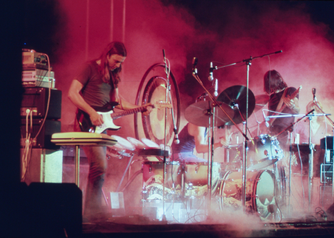 Pink Floyd playing on stage surrounded with smoke and illuminated with red stage lights during a concert at Merriweather Post Pavilion in Columbia, Maryland, in June 1973.