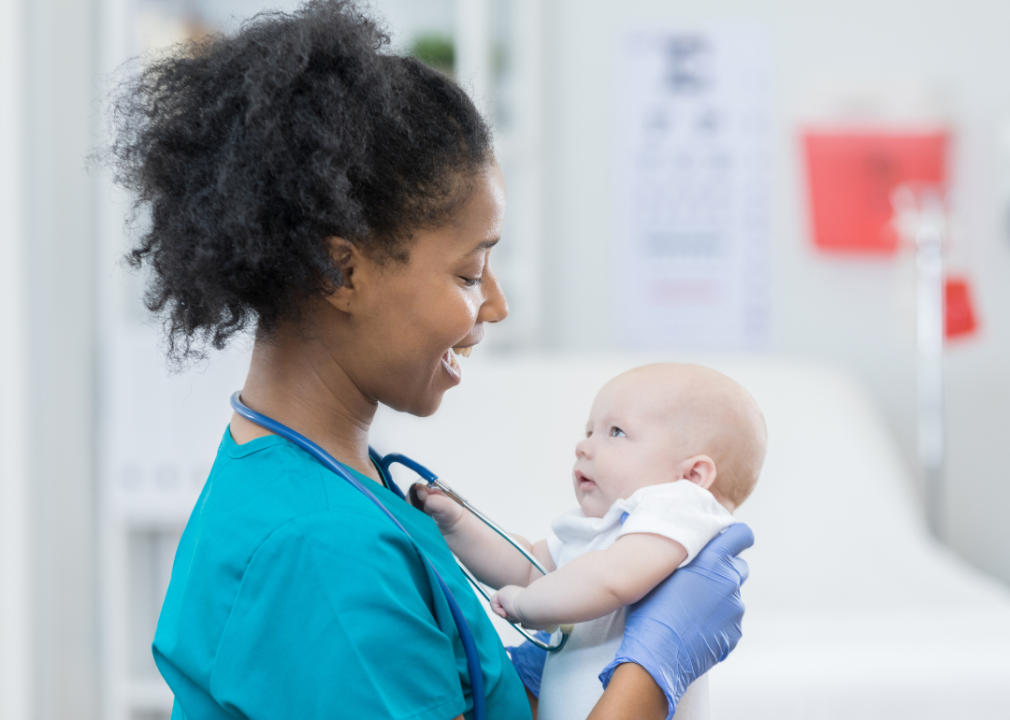 A nurse holding a baby