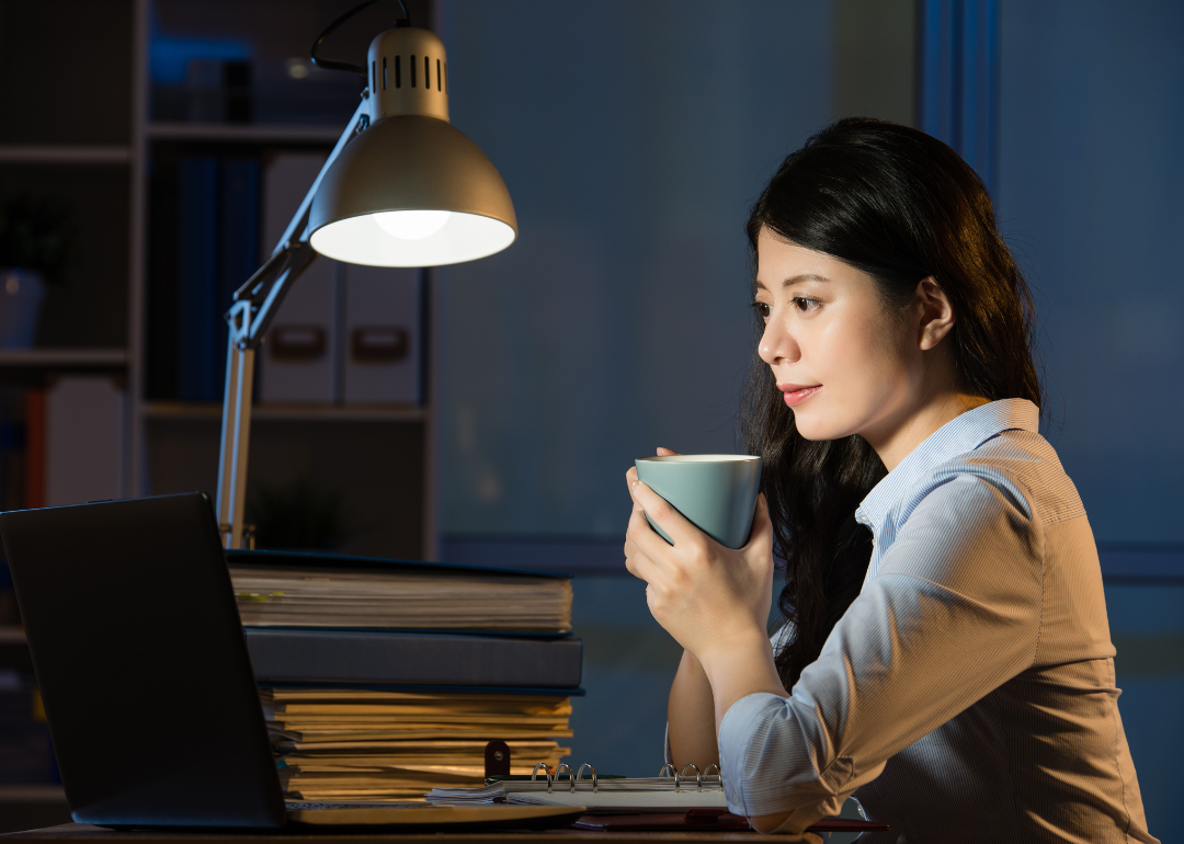 A person drinking coffee late at night