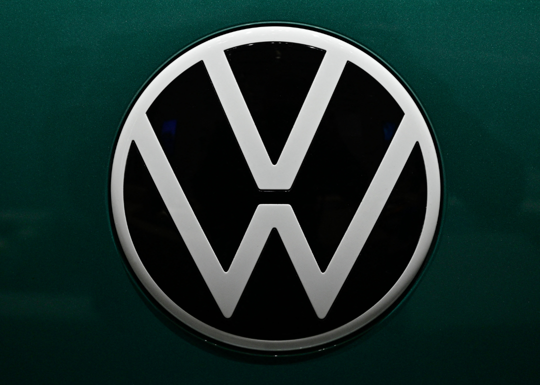 The Volkswagen logo on a green car.
