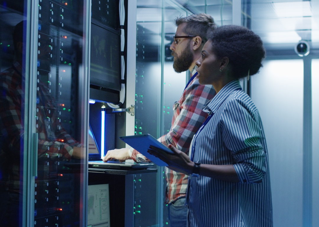 Two technicians examine a server.