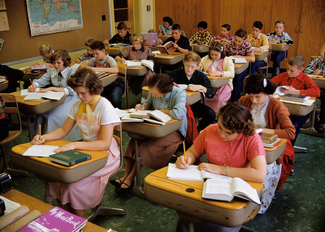 High school students writing at their desks in the 1950s.