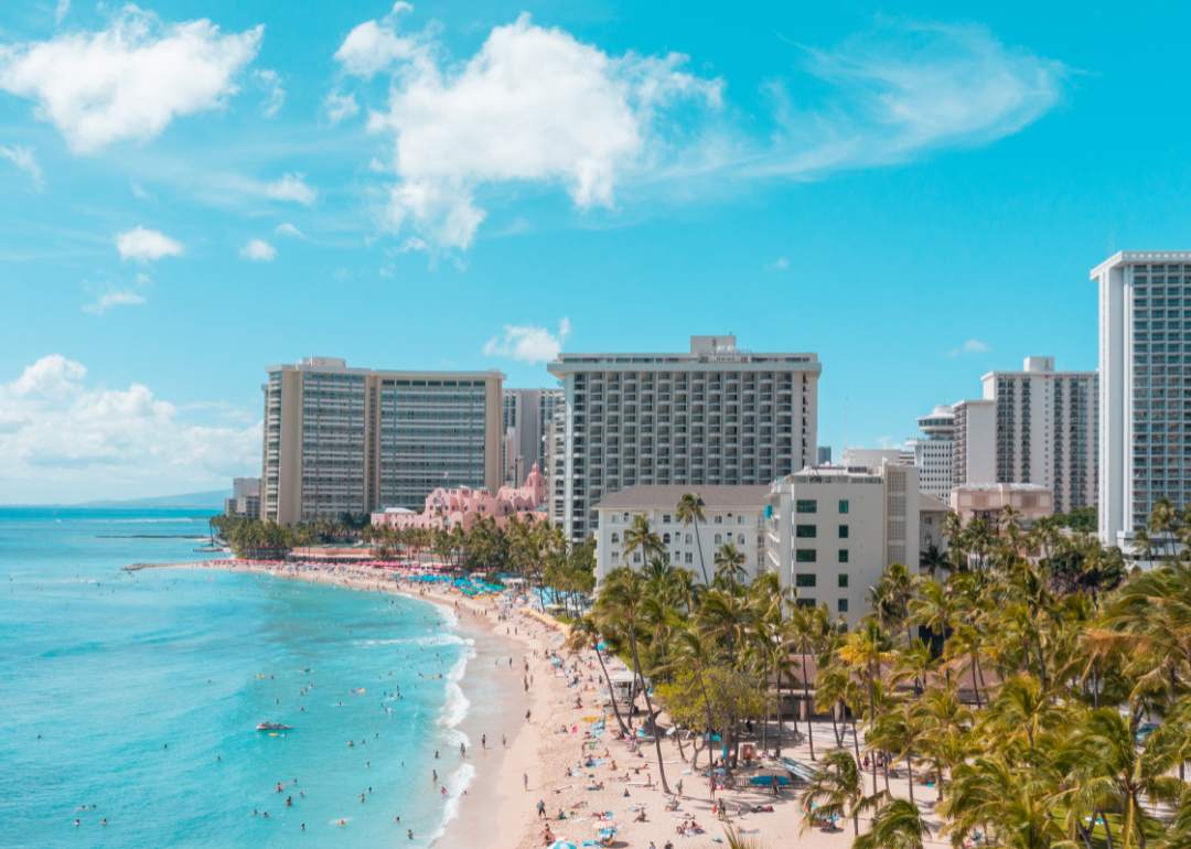 People on the beach and in the water of Waikiki Beach.