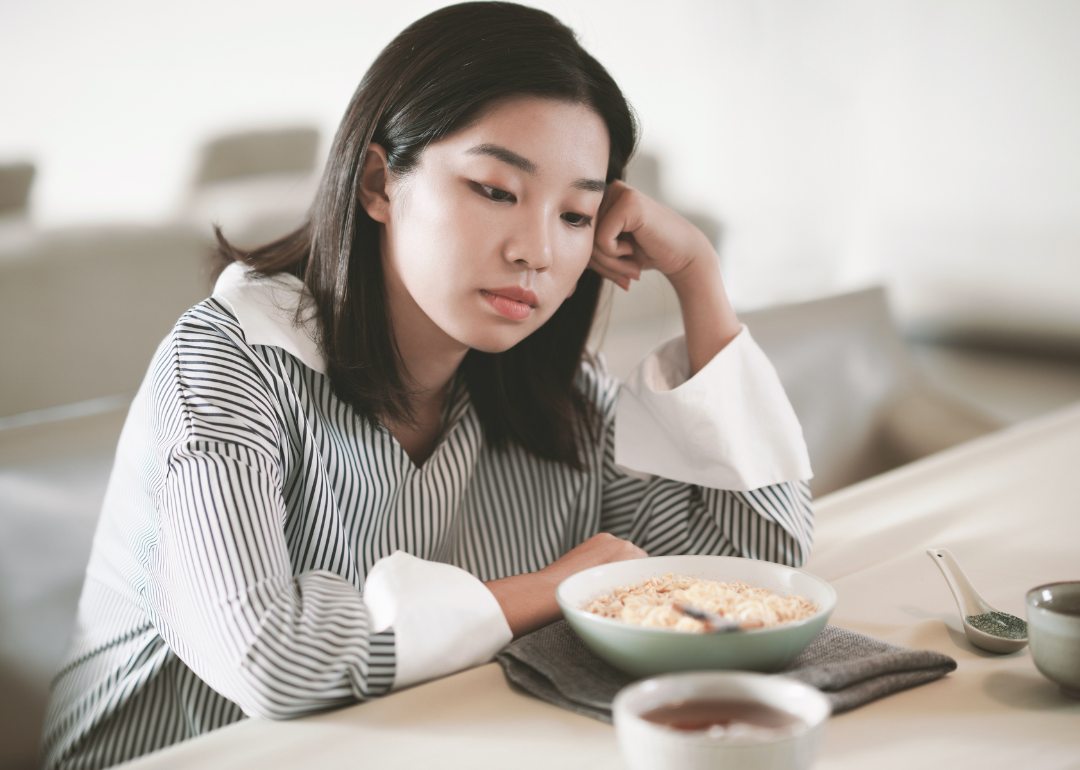 A young person eating alone at home