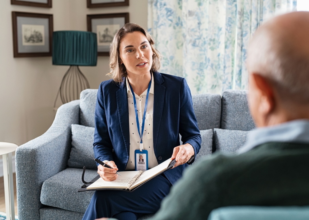 A social worker talking to a person during a home visit.