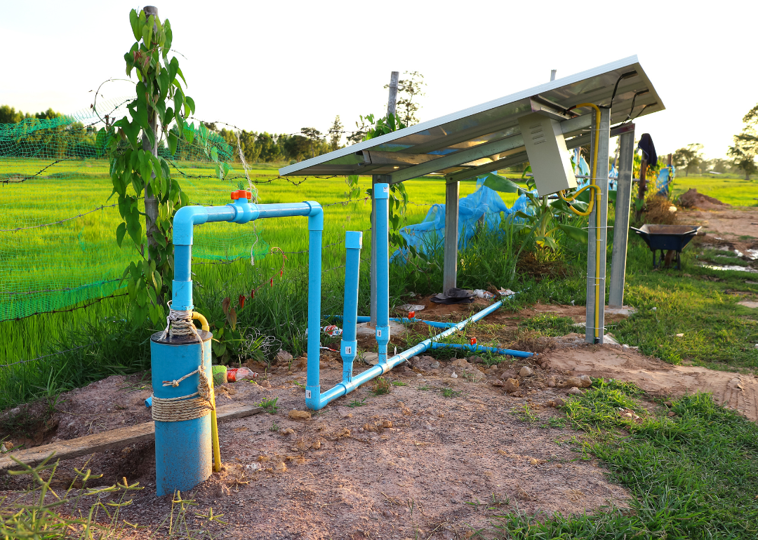 A solar cell kit being used to pump water used on a farm.