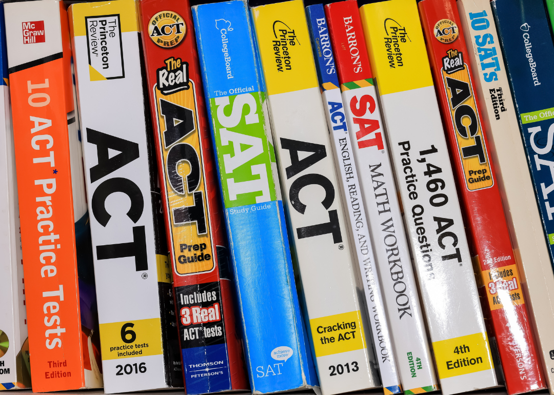 A row of ACT and SAT books that contain standardized practice tests for university admissions in USA
