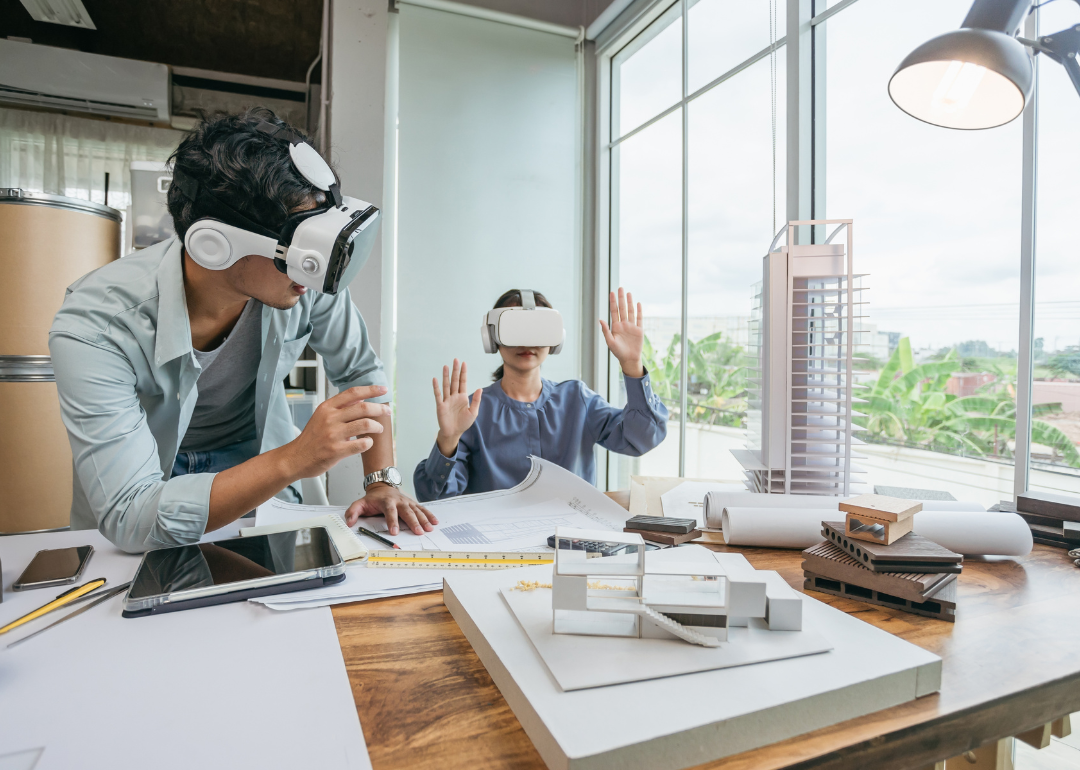An architect wearing a VR headset for BIM technology to create a 3D model building