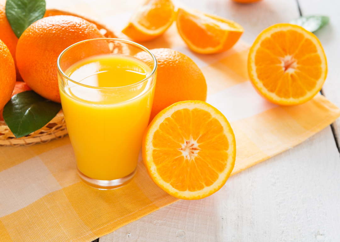 Oranges and orange juice on a placemat.