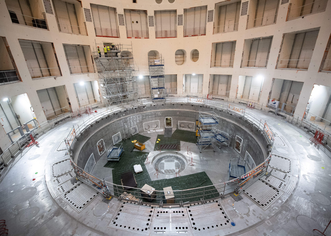 Technicians working on the bioshield inside the Tokamak Building during the launch of the assembly stage of nuclear fusion machine "Tokamak" of the International Thermonuclear Experimental Reactor (ITER) in Saint-Paul-les-Durance, southeastern France, on July 28, 2020.