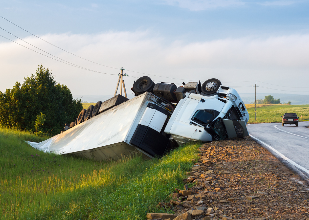 A trucking lying in a ditch after an accident.