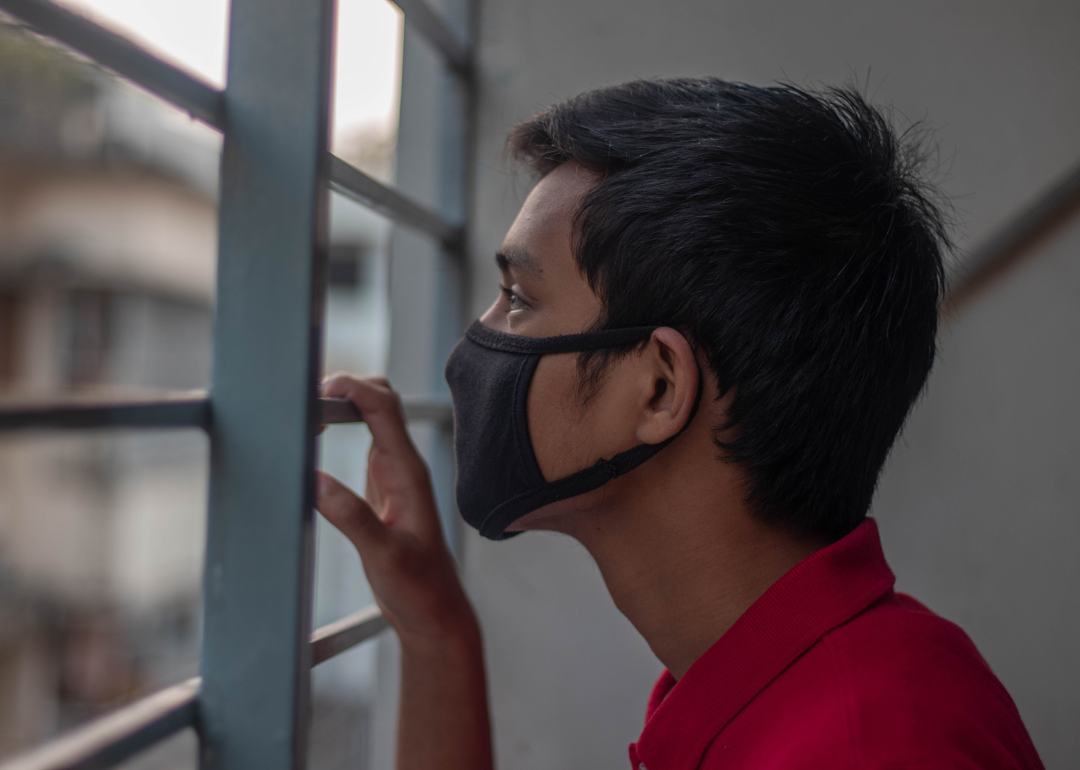 A young person at home during the pandemic wearing a mask
