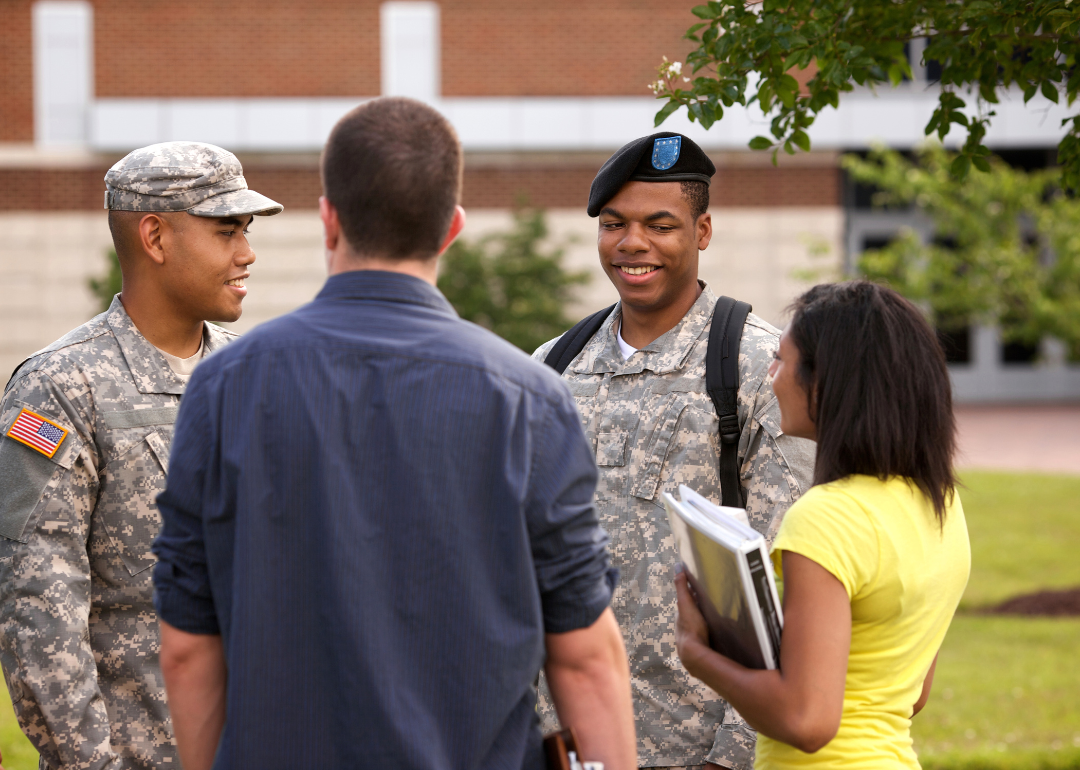 ROTC soldiers speaking with students on campus.