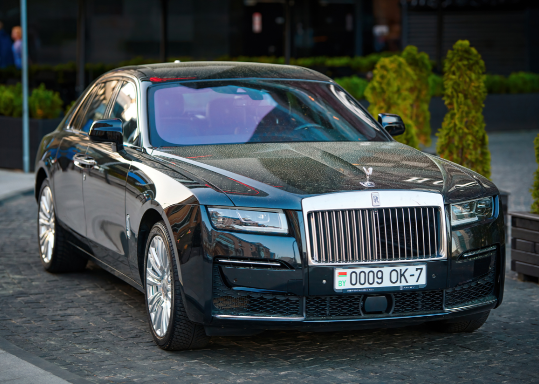 A Rolls-Royce Ghost in a hotel parking lot.