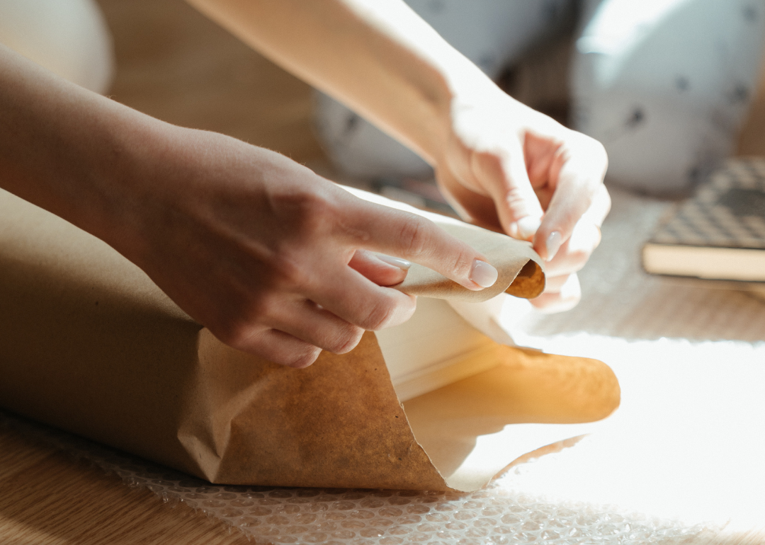 A worker wraps up a package.