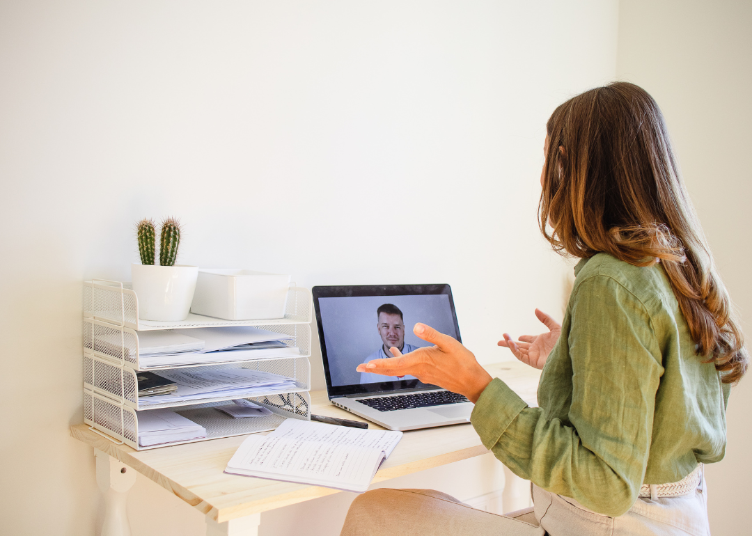 A person taking a video call from a small office.