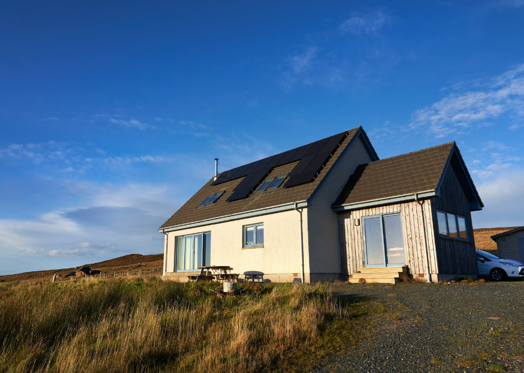 A home in a remote area that is powered by solar panels.