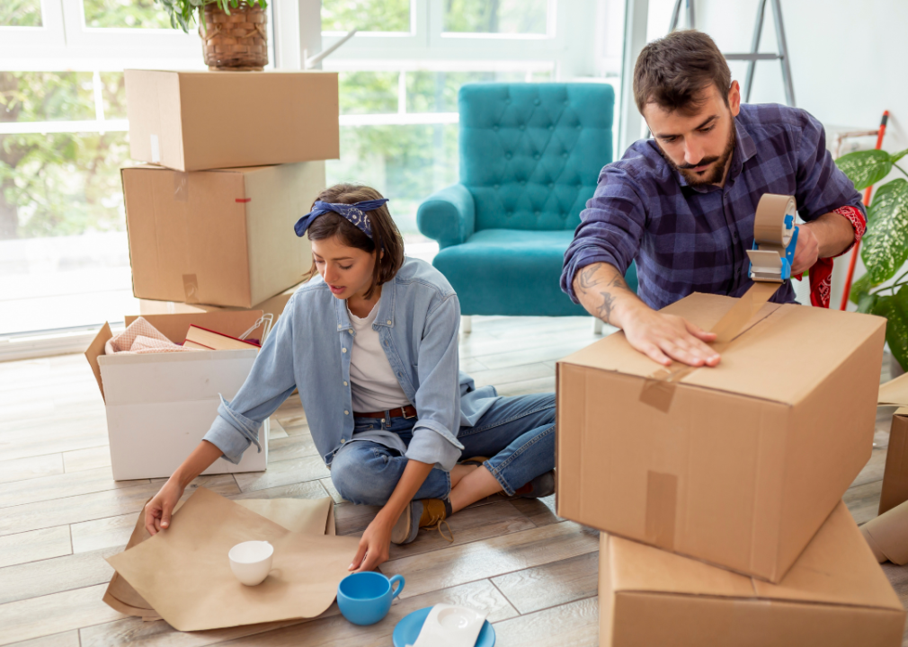 A couple packing boxes to move house