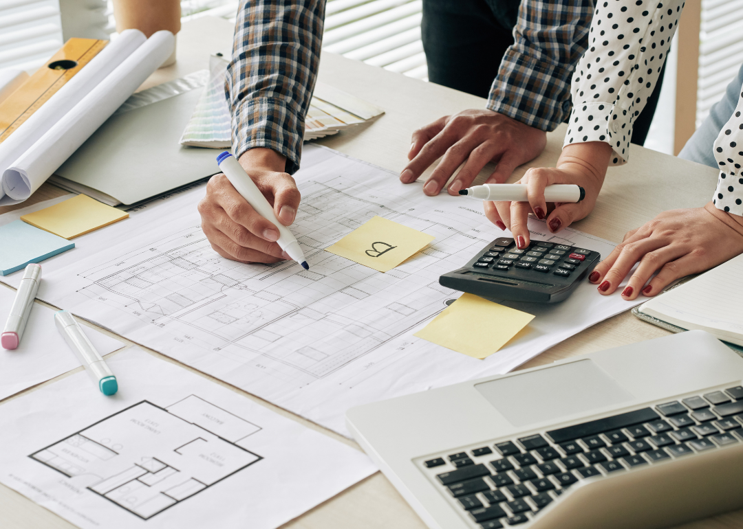 Cost estimators calculating the cost of a constrution project