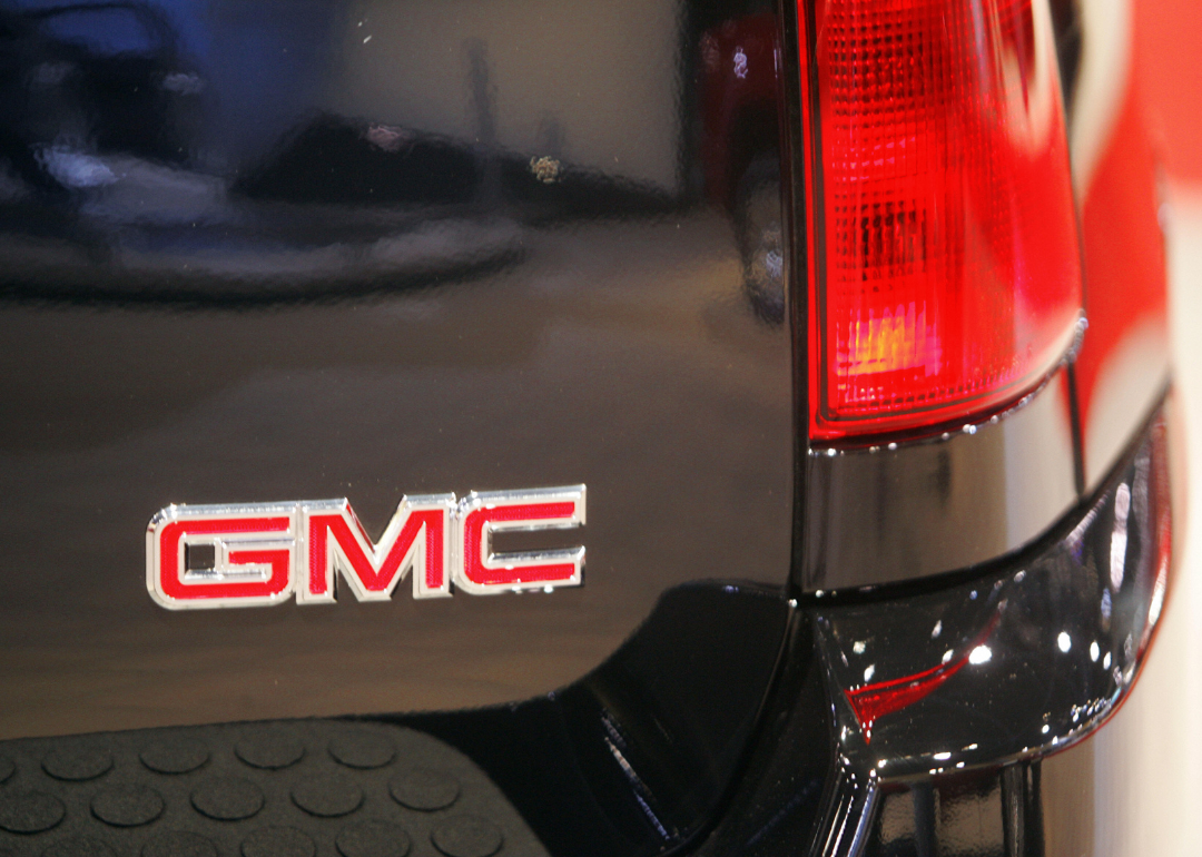 The GMC company logo on the bumper of a car.